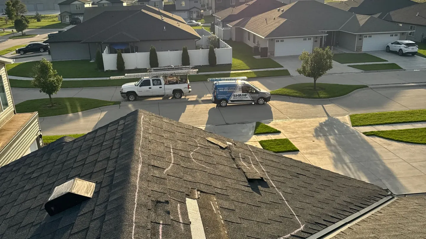 Aerial view of a completed asphalt shingle roof at sunset in eastern Nebraska