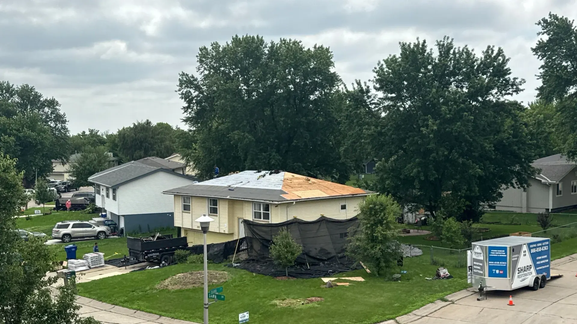 Sharp Restoration crew replacing a storm-damaged roof on a home in Lincoln, Nebraska