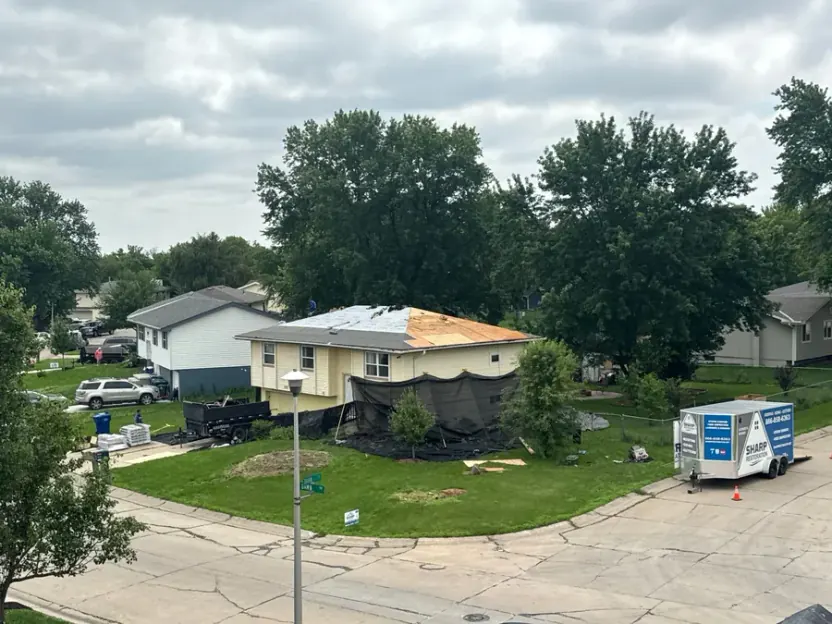 Aerial view of a Sharp Restoration roof tear-off in progress on a Lincoln, NE home