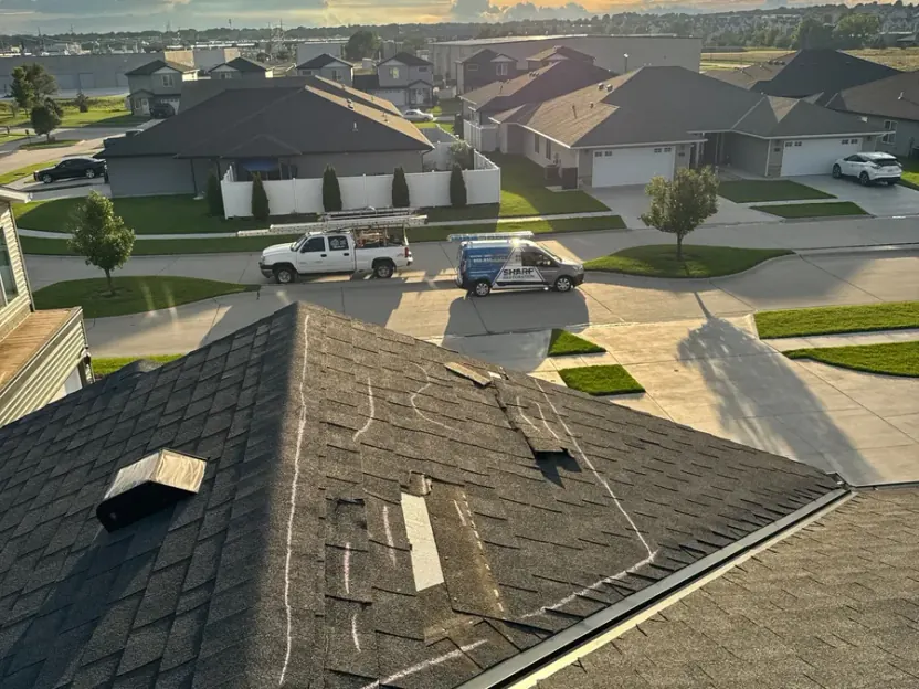 Aerial view of a completed asphalt shingle roof at sunset in eastern Nebraska