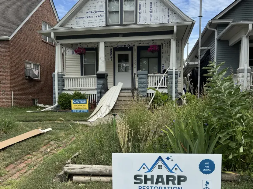 Sharp Restoration roofing, siding and gutters yard sign at a Lincoln, NE project